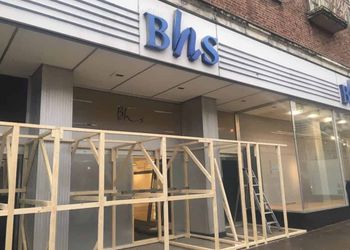 The wooden barrier at BHS on South Street, Exeter, Devon. See SWNS story SWBHS; The wooden barrier - around 10 ft tall - was being constructed today in the entrance of BHS on South Street. Workers say it is to stop rough sleepers from gathering in the doorways. The store has been vacant since the collapse of Sir Philip Green's former chain in August last year. In recent months its entrances had become a shelter to some of Exeter's homeless - including Justin Wilson, 41, and Tia Bamford, 30, who set up a camp beneath the store's southern doorway.