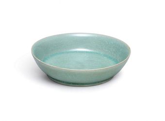 A small but highly-important ceramic dish from Imperial China is expected to sell for more than £10 MILLION at auction. See SWNS story SWBOWL; The brush washer is around 1,000 years old and was commissioned by the imperial court during the Song dynasty. And it was made by Ru guanyao, which is one of the most revered of the Five Great Kilns used during this period. The brush washer, which has a diameter of just 13cm, has a glowing, intense blue-green glaze and 'ice crackle' pattern. It is most likely the dish was made between 1086 and 1106 and it is extraordinarily rare for a Ru vessel to be sold at auction. There are thought to be just 87 pieces of Ru official ware in existence and only six have been sold publicly since 1940. The brush washer is one of only four in private hands and Sothebys will auction it in Hong Kong on October 3.
