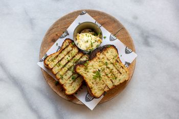 Caravan's Jalapeño cornbread, chipotle butter, coriander, lime Caravan